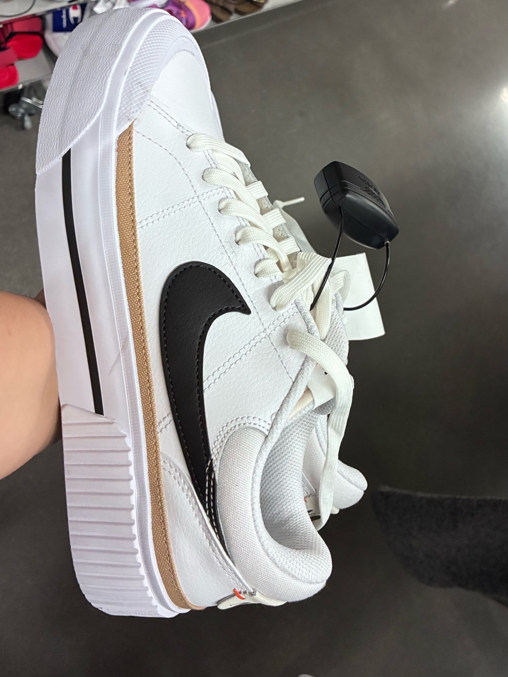 Nike White Sneaker with Black Swoosh and Tan Accent
